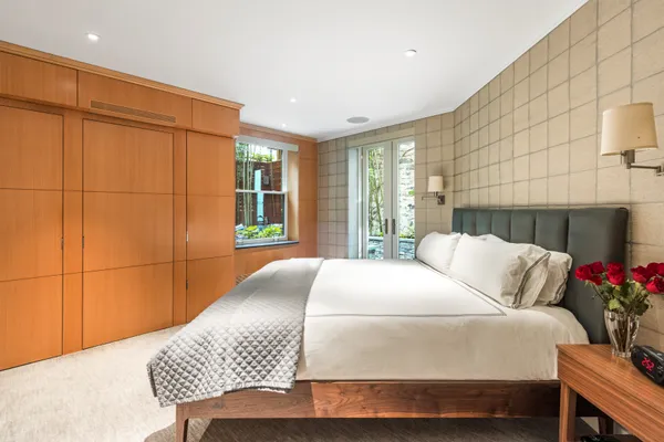 a bedroom with a bed and a potted plant