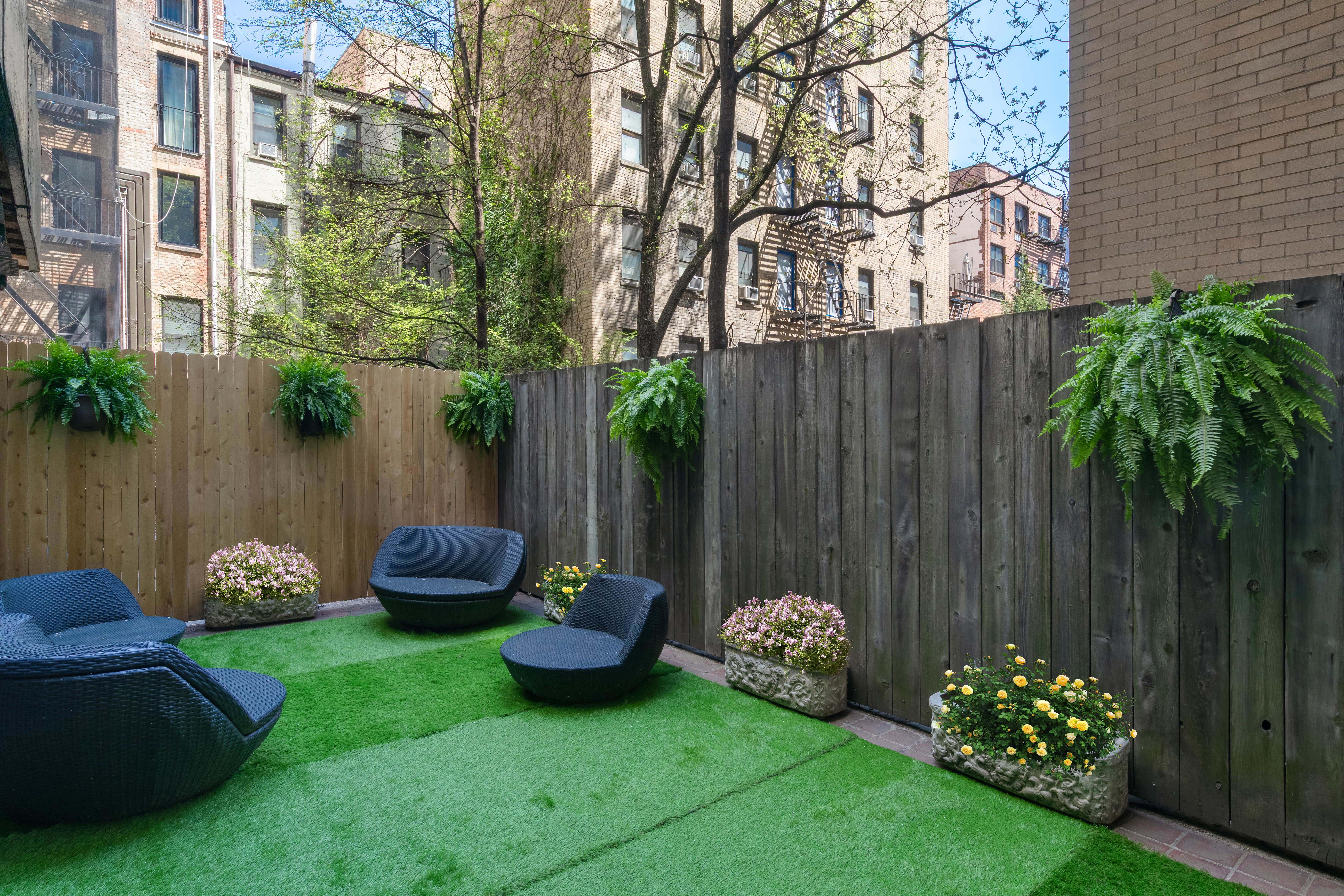 207 East 74th Street, Unit 1J Manhattan, NY 10021 - Photo 1 of 9 a garden view with a seating space