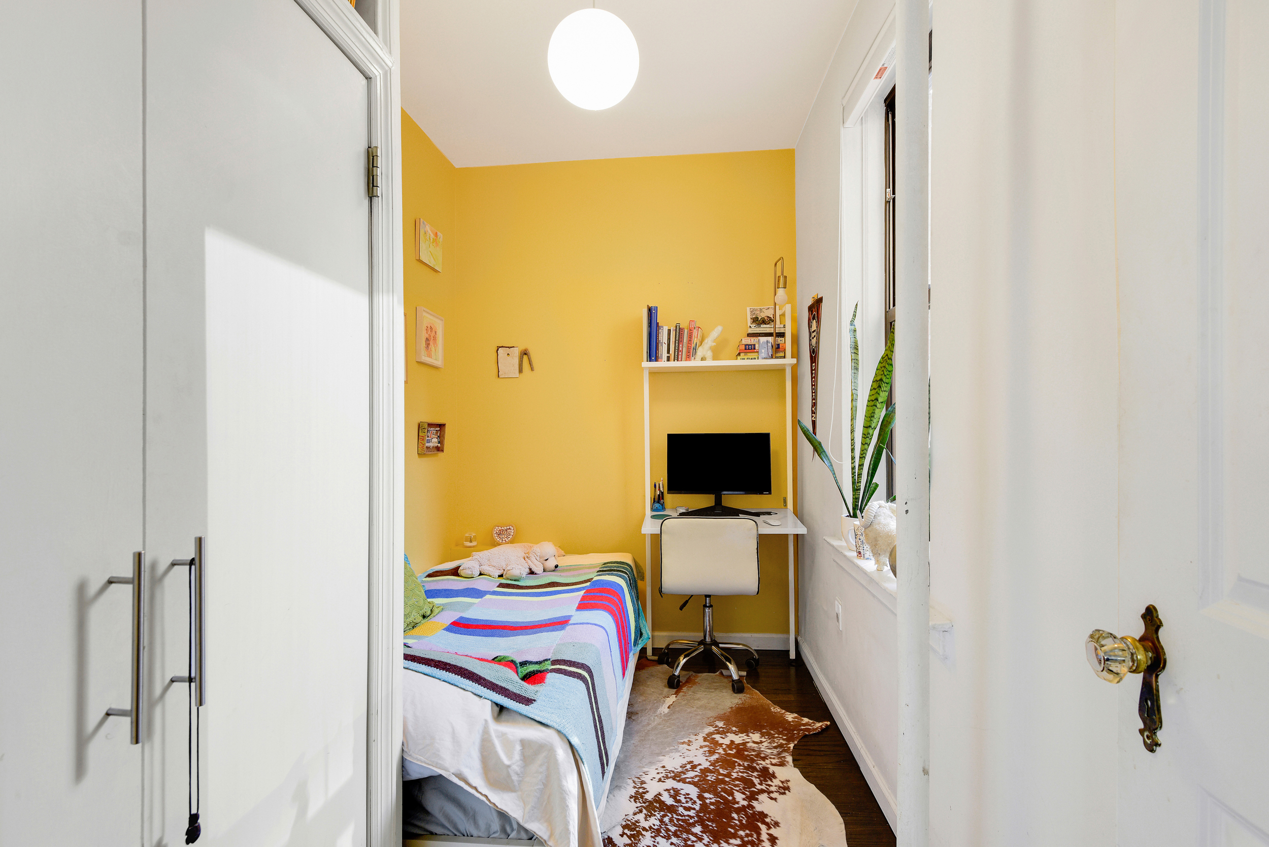 253 West 16th Street, Unit 3A Manhattan, NY 10011 - Photo 10 of 13 a bedroom with a bed and a tv