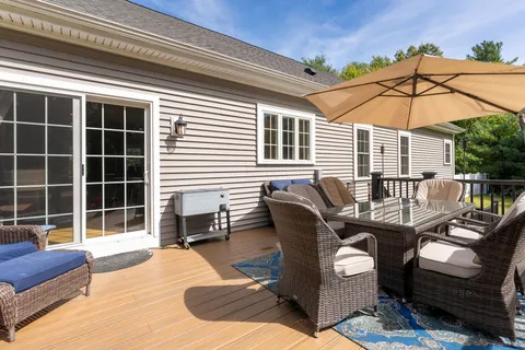 a balcony with furniture and a potted plant