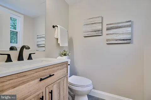 a bathroom with a sink a toilet and vanity