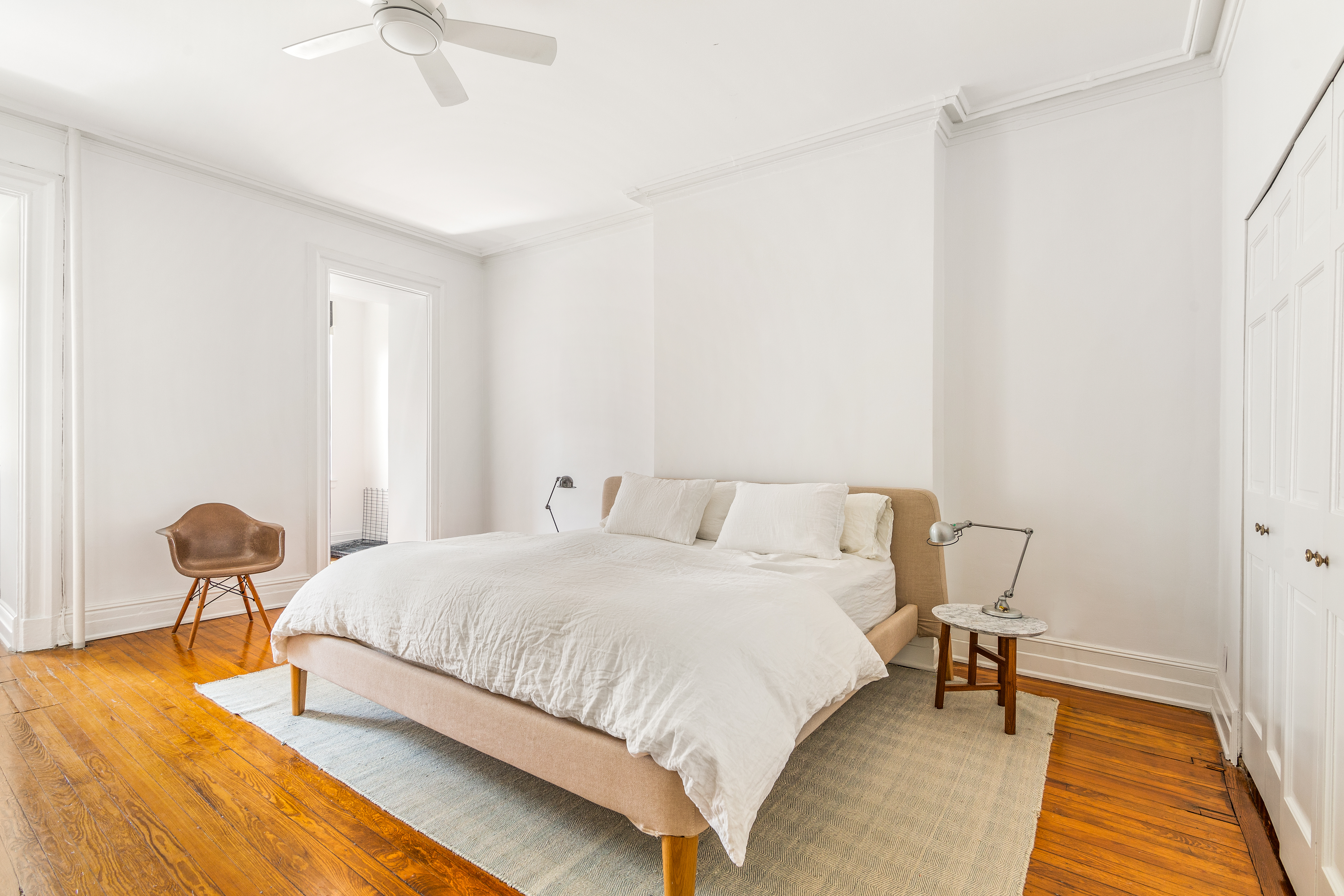 176 Warren Street Brooklyn, NY 11201 - Photo 5 of 13 a bedroom with a bed and a chandelier