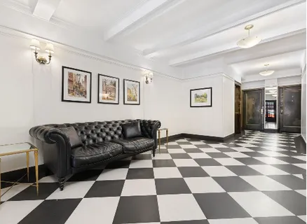 a living room with a black white checkered floor with a black white checkered floor