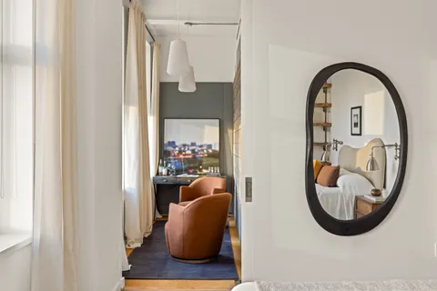 a view of a balcony with a potted plant and a table