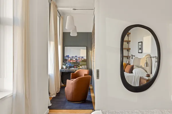 a view of a balcony with a potted plant and a table