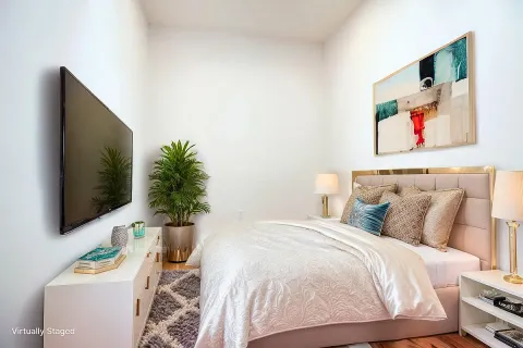 a bedroom with a bed and a flat screen tv