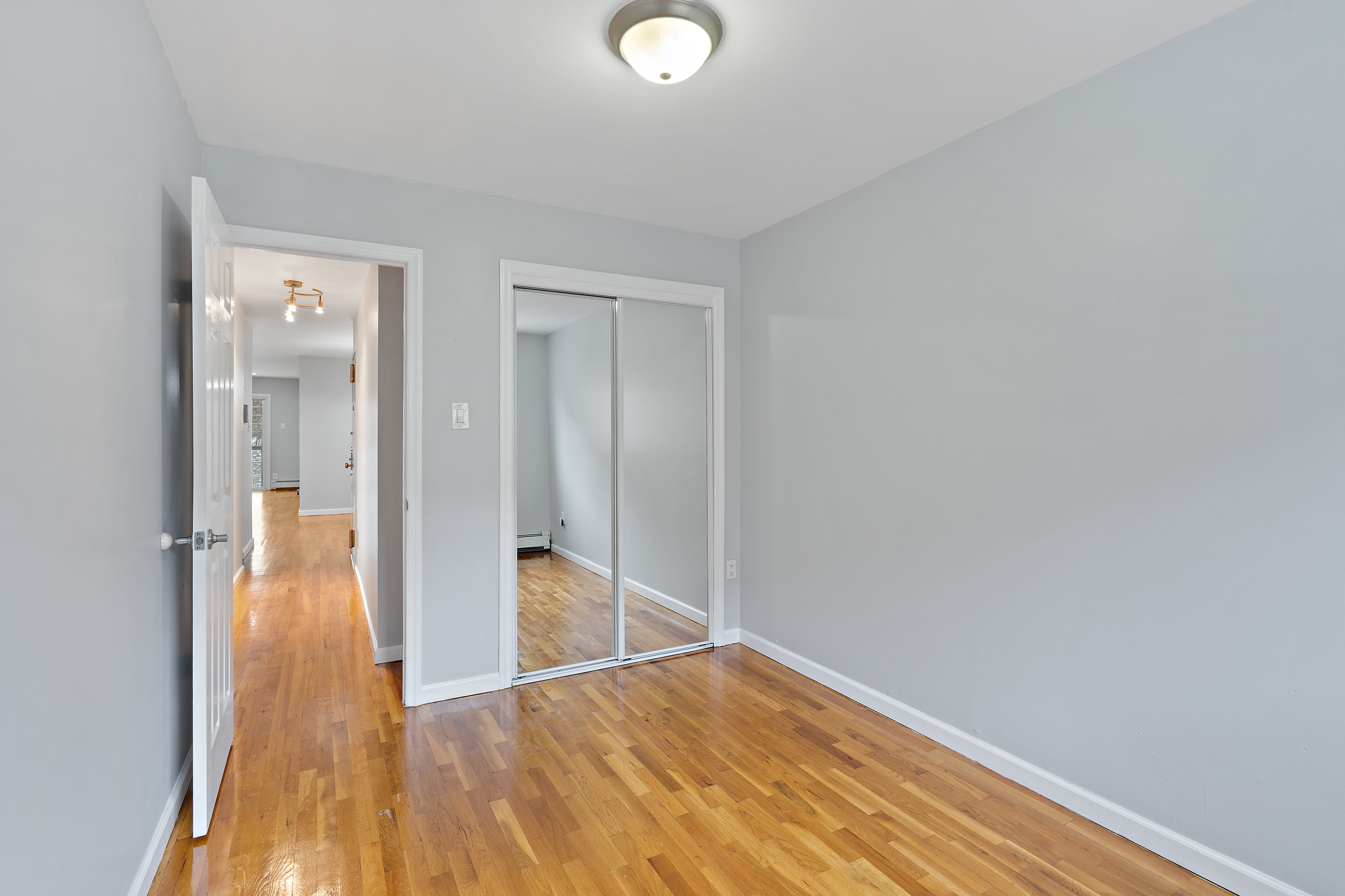 3230 Johnson Avenue, Unit 3 Bronx, NY 10463 - Photo 12 of 21 a view of a hallway with wooden floor