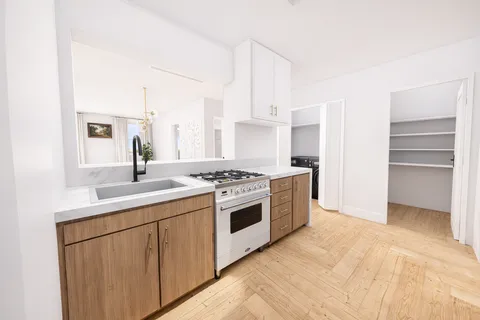 a kitchen with a sink stove and cabinets