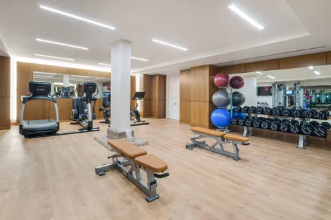 a view of a gym room with gym equipment