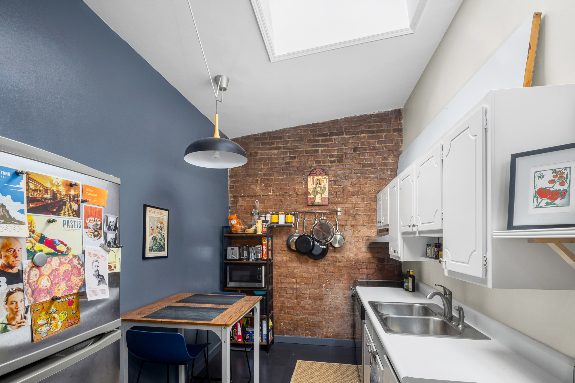 342 West 22nd Street, Unit 3 Manhattan, NY 10011 - Photo 5 of 11 a dining room with furniture and a window