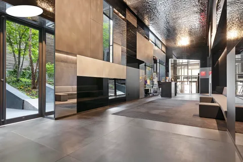 a view of an empty room with a fireplace and windows