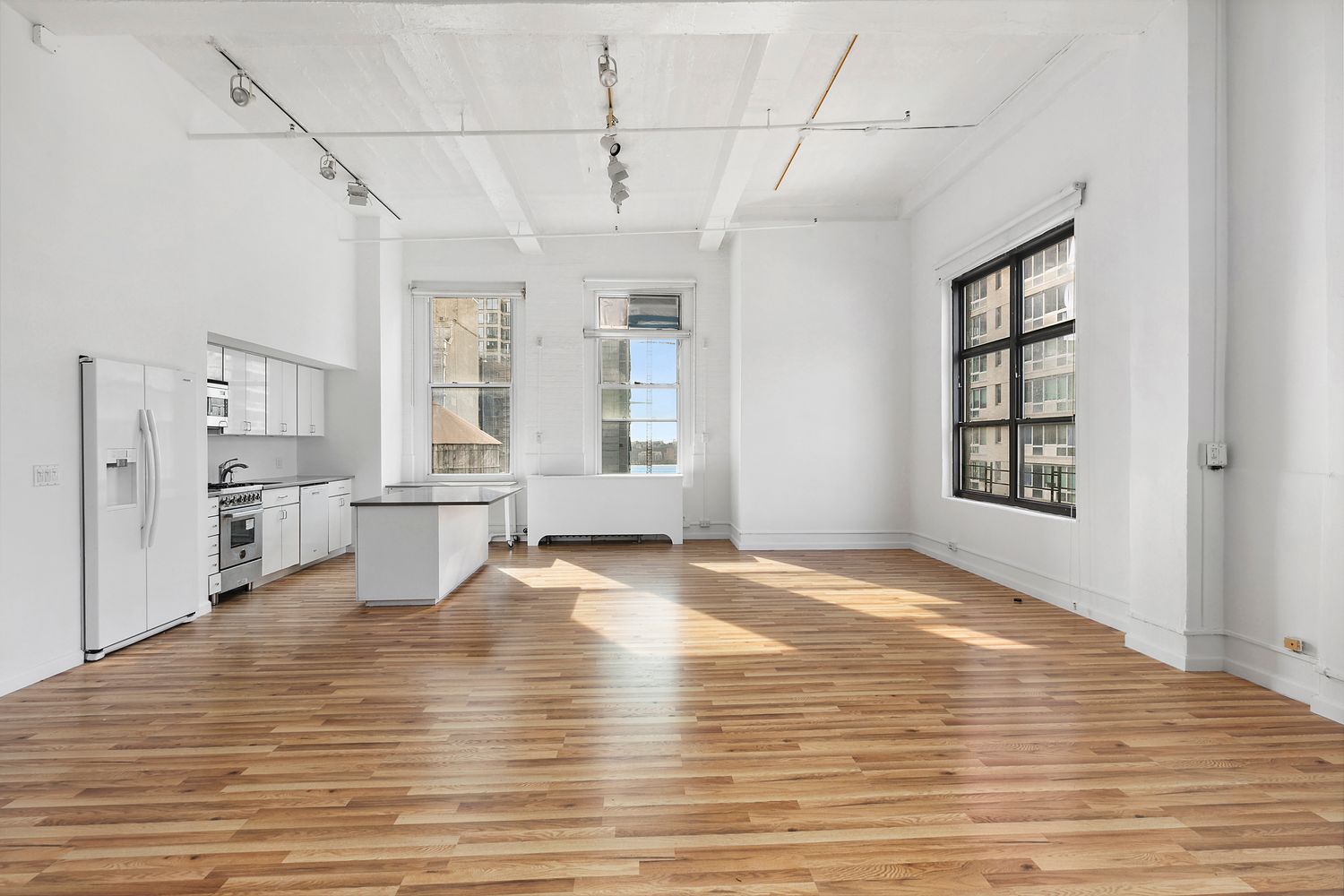 448 West 37th Street, Unit PHA Manhattan, NY 10018 - Photo 2 of 7 a view of empty room with wooden floor and fan