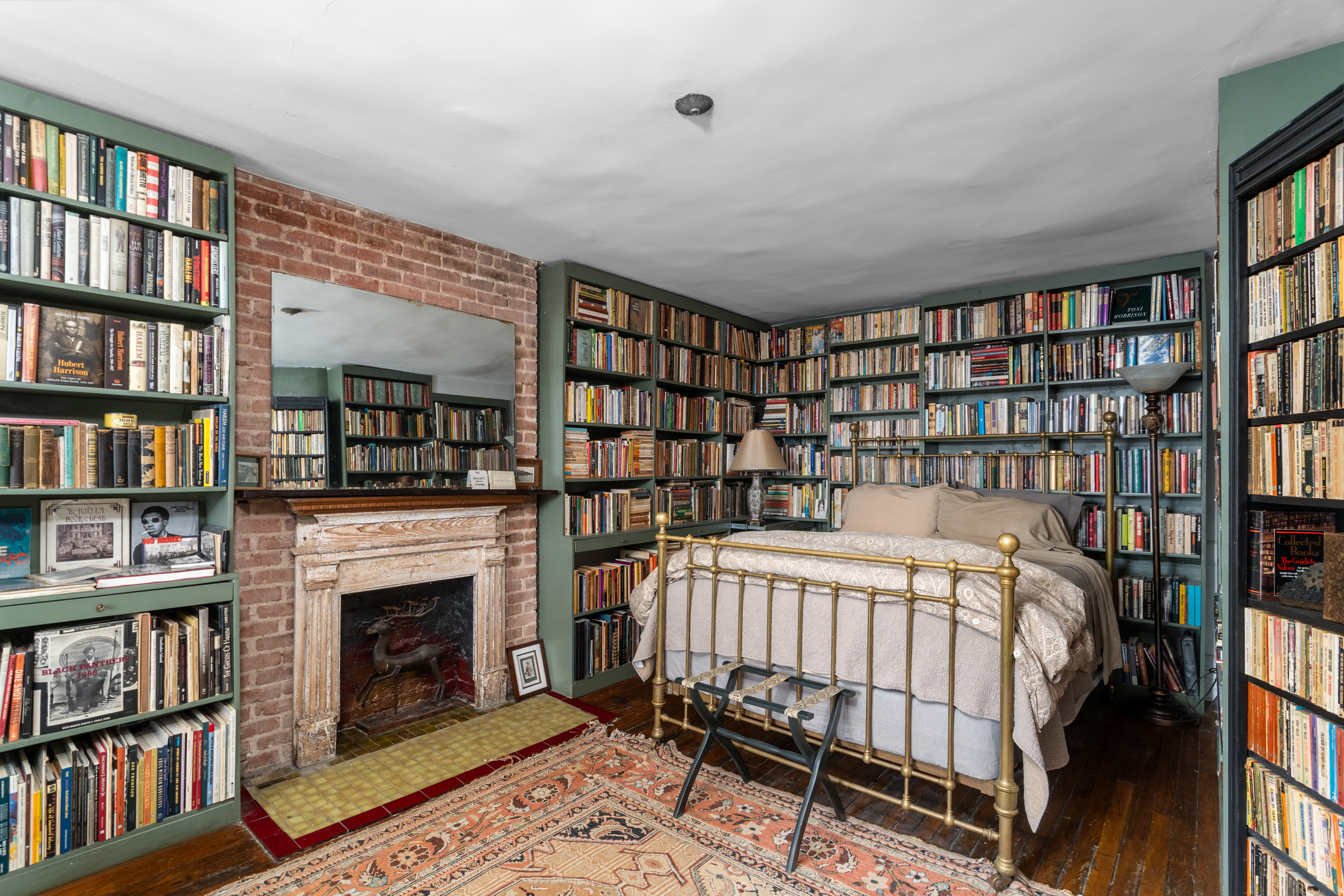 426 West 160th Street Manhattan, NY 10032 - Photo 23 of 33 a bedroom with a bed a book shelf and a book shelf