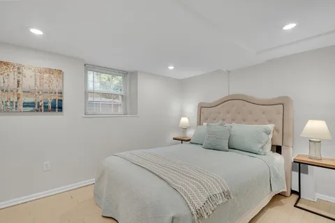 a bedroom with a bed and night stand