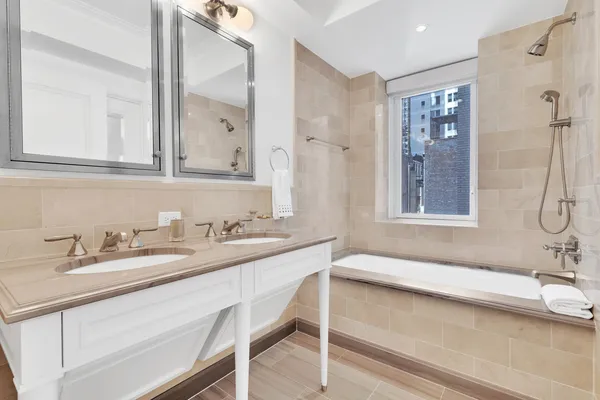 a bathroom with a sink and a mirror a bathtub