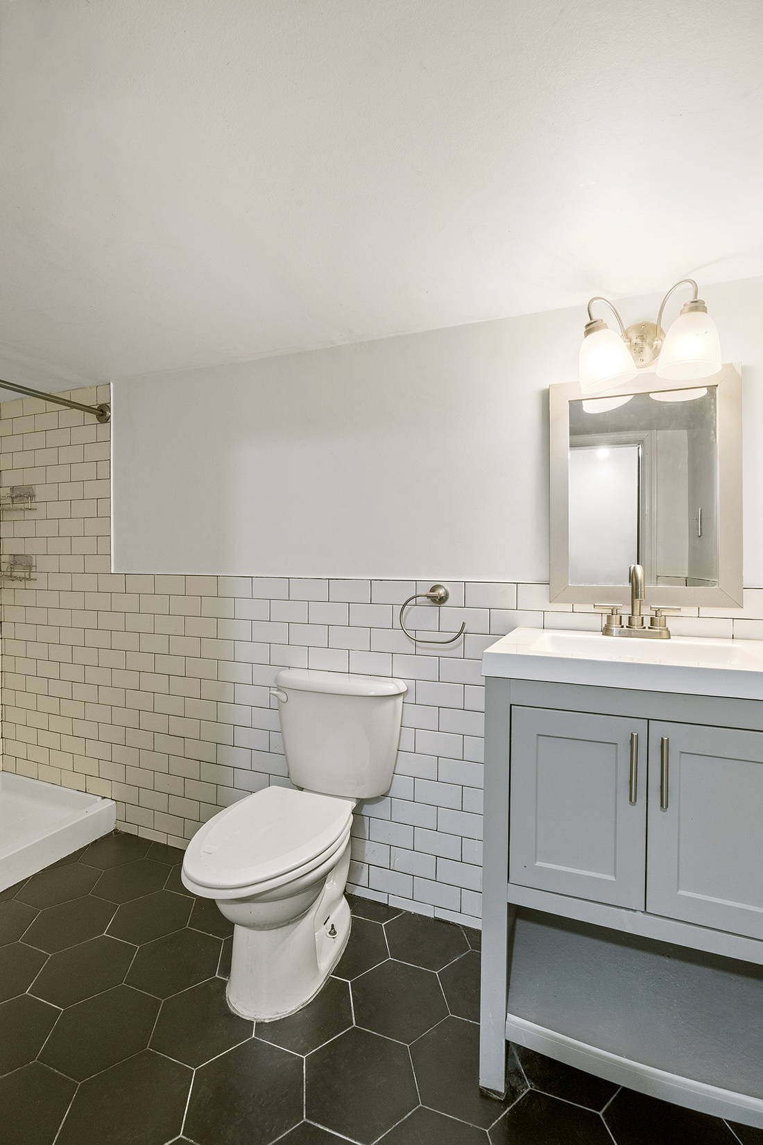 1437 Lincoln Place Brooklyn, NY 11213 - Photo 9 of 12 a bathroom with a toilet sink and mirror