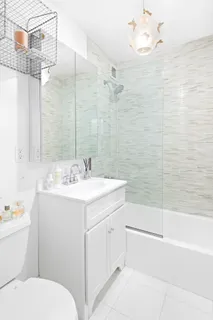 a bathroom with a sink toilet vanity and shower