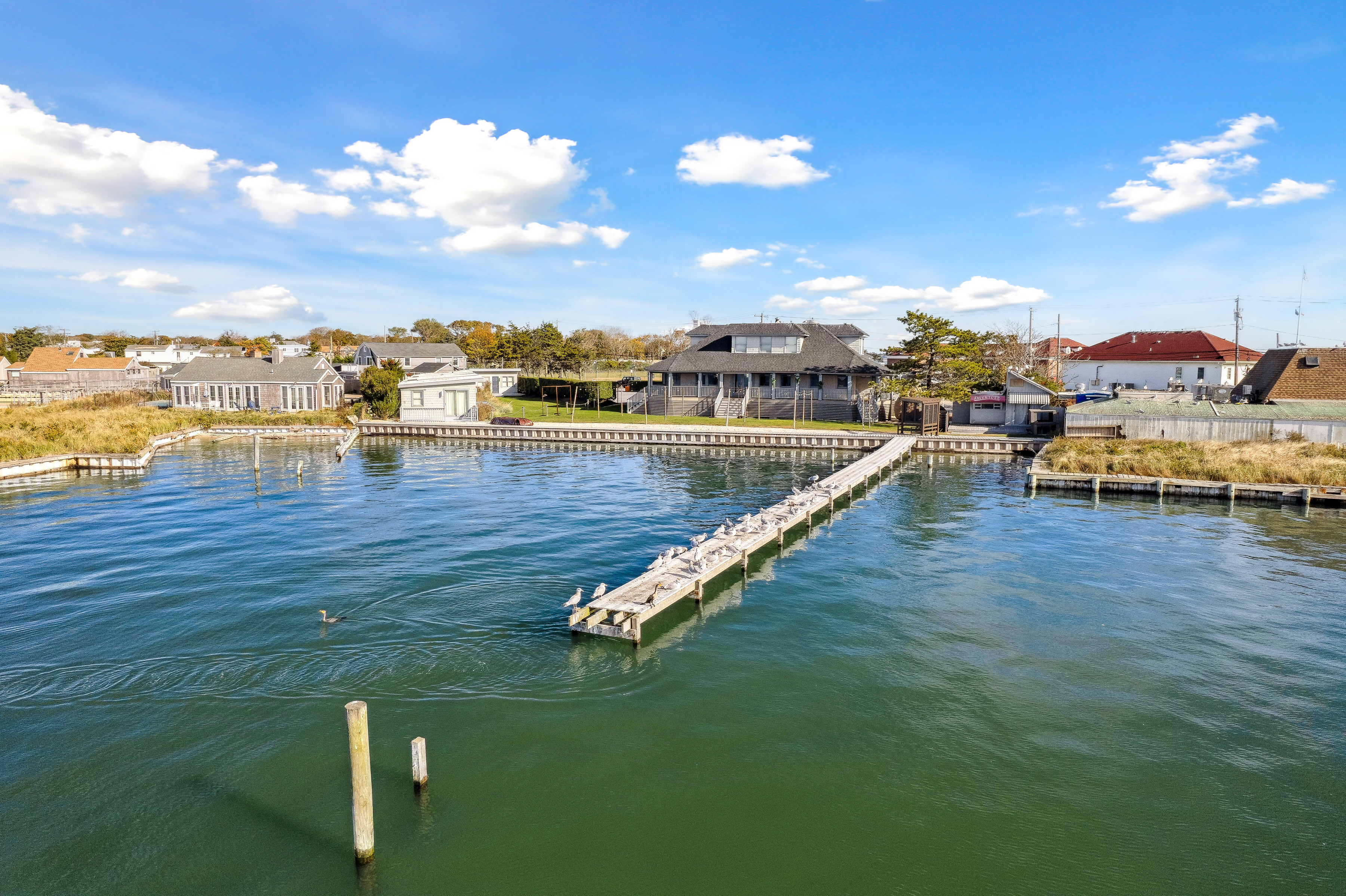 32 Lighthouse Road Hampton Bays, NY 11946 - Photo 12 of 51 a view of swimming pool with outdoor seating and ocean view