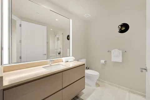 a living room with furniture and view of kitchen