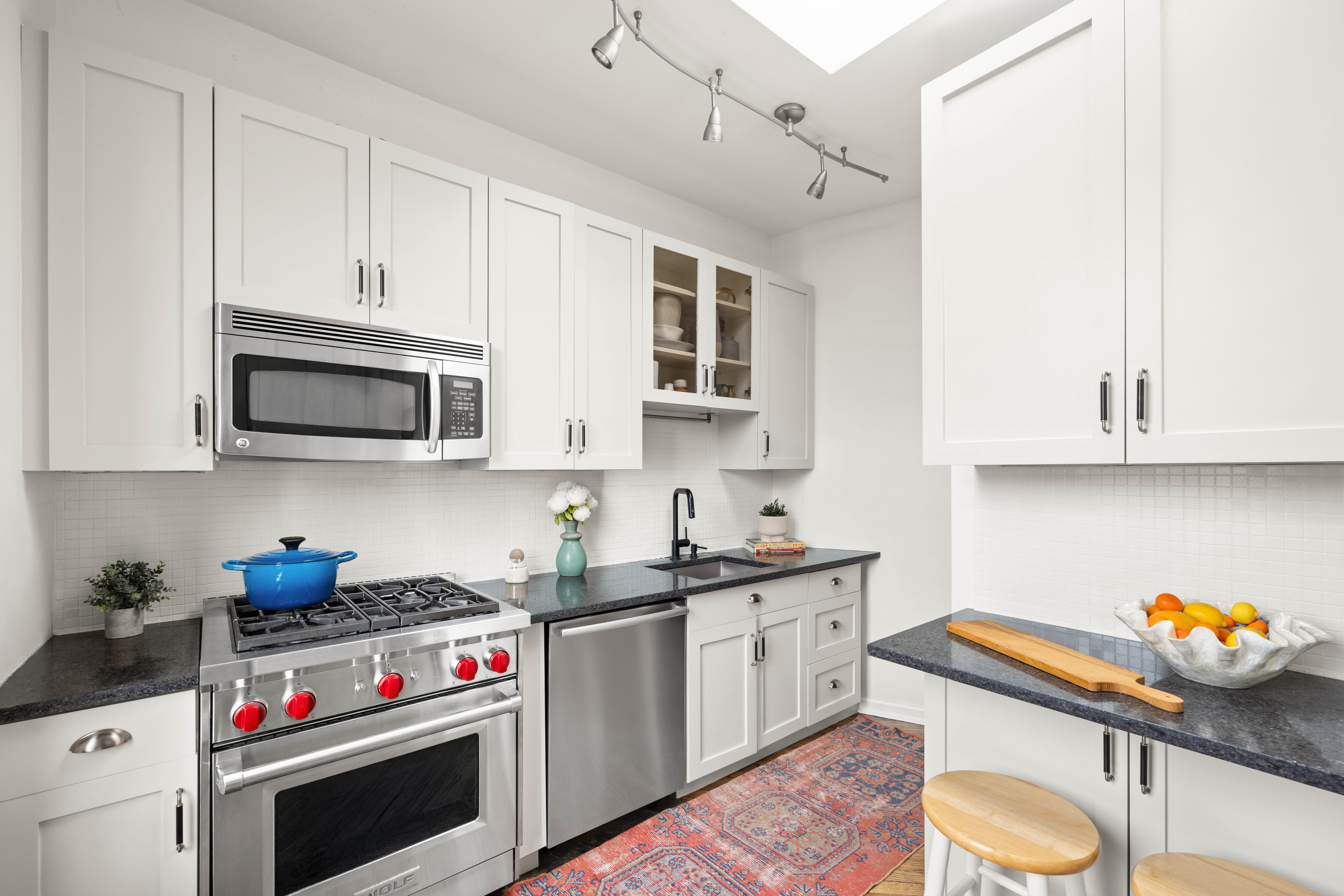 240 Prospect Place, Unit 9 Brooklyn, NY 11238 - Photo 5 of 11 a kitchen with stainless steel appliances granite countertop a sink a stove and a microwave