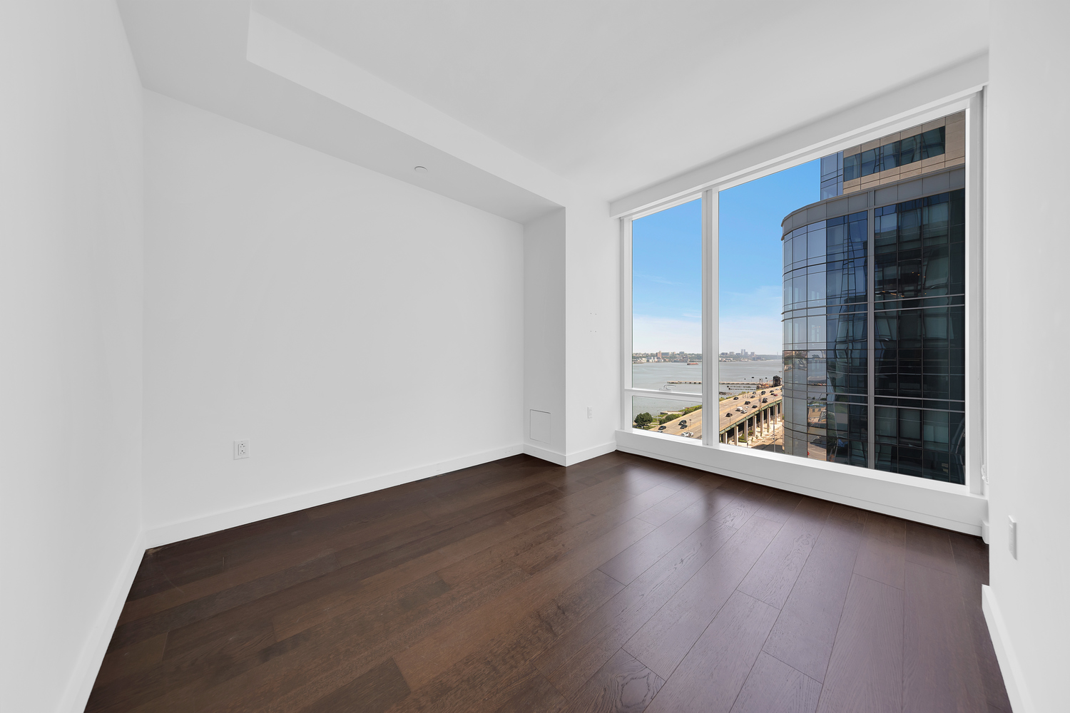 30 Riverside Boulevard, Unit 1414 Manhattan, NY 10069 - Photo 5 of 25 a view of an empty room with wooden floor and a window