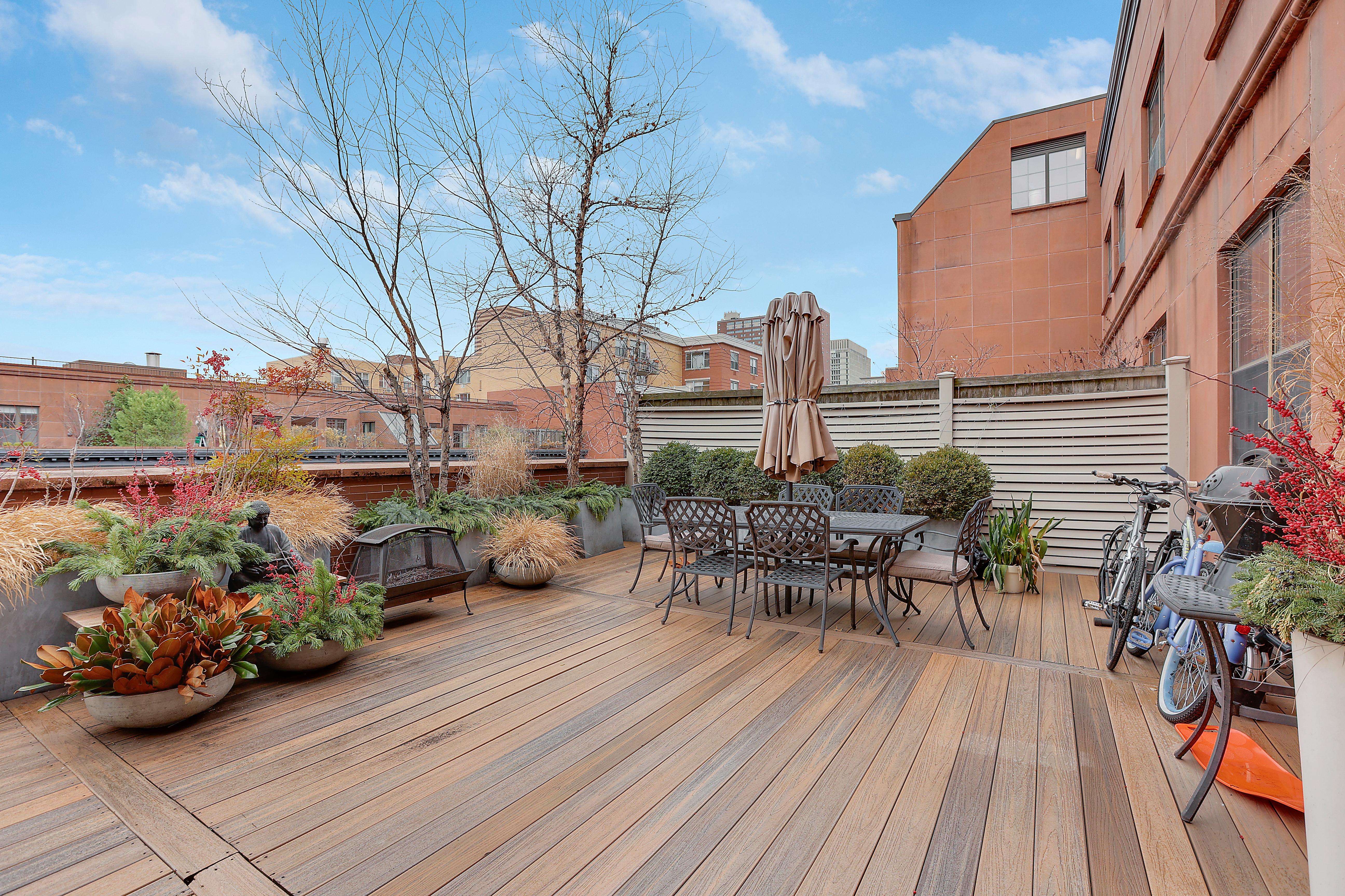 313 West 119th Street, Unit PHE Manhattan, NY 10027 - Photo 2 of 19 a view of a chairs and table on the wooden deck