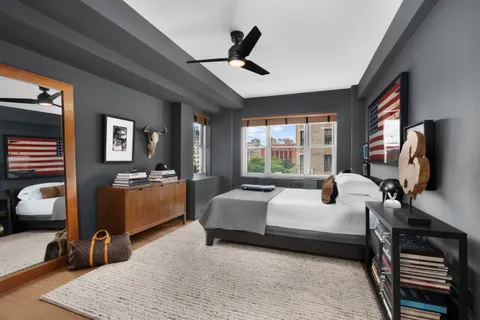 a bedroom with a bed a couch and a dresser