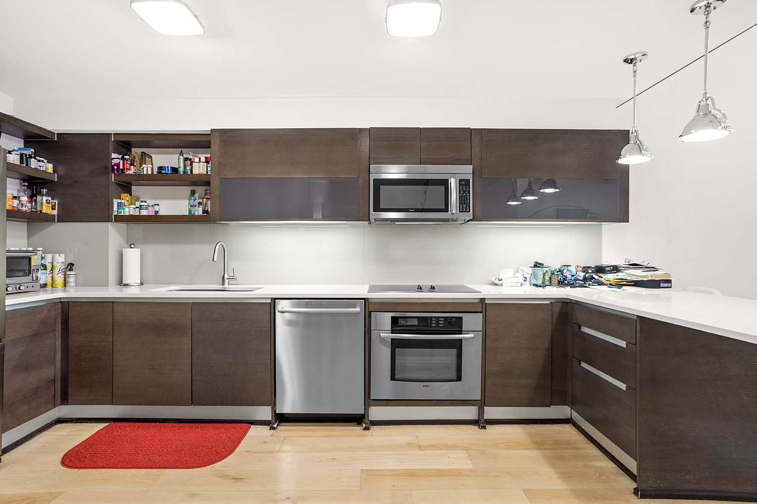 125 East 12th Street, Unit 1E Manhattan, NY 10003 - Photo 5 of 16 a kitchen with stainless steel appliances granite countertop a sink and a stove