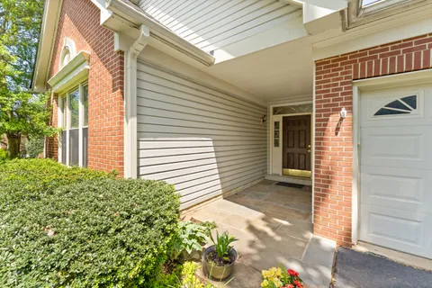 a view of a house with yard and potted plants