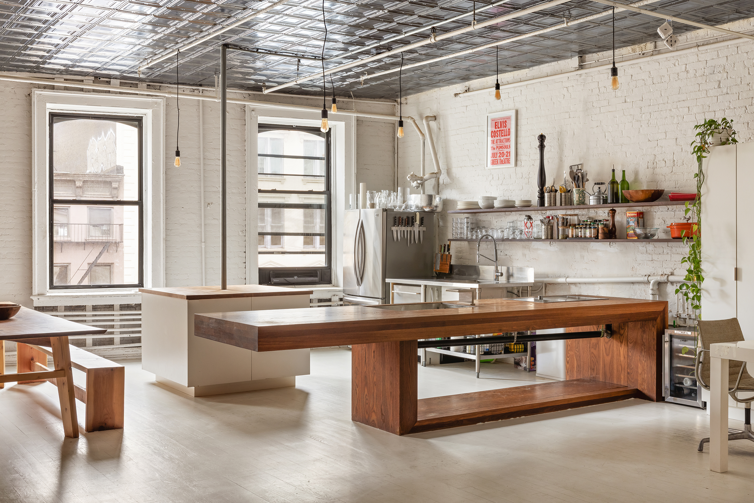 49 Howard Street, Unit 4S Manhattan, NY 10013 - Photo 3 of 12 a kitchen with stainless steel appliances granite countertop a sink and wooden cabinets