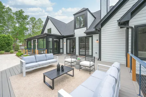 a swimming pool with outdoor seating and yard