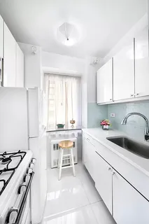 a kitchen with a sink stove top oven and cabinets