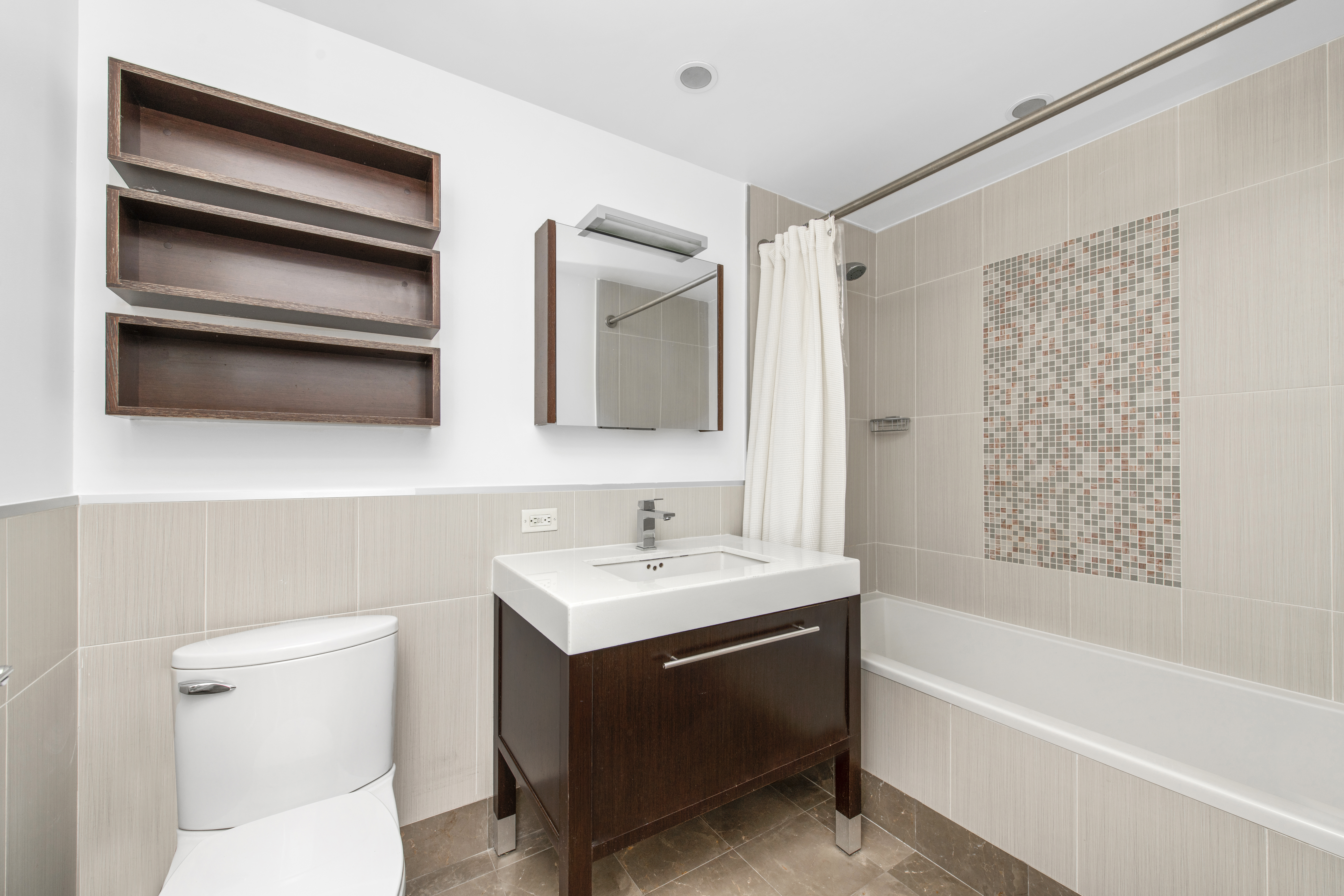 225 East 34th Street, Unit 9C Manhattan, NY 10016 - Photo 7 of 19 a bathroom with a sink a toilet and a bathtub