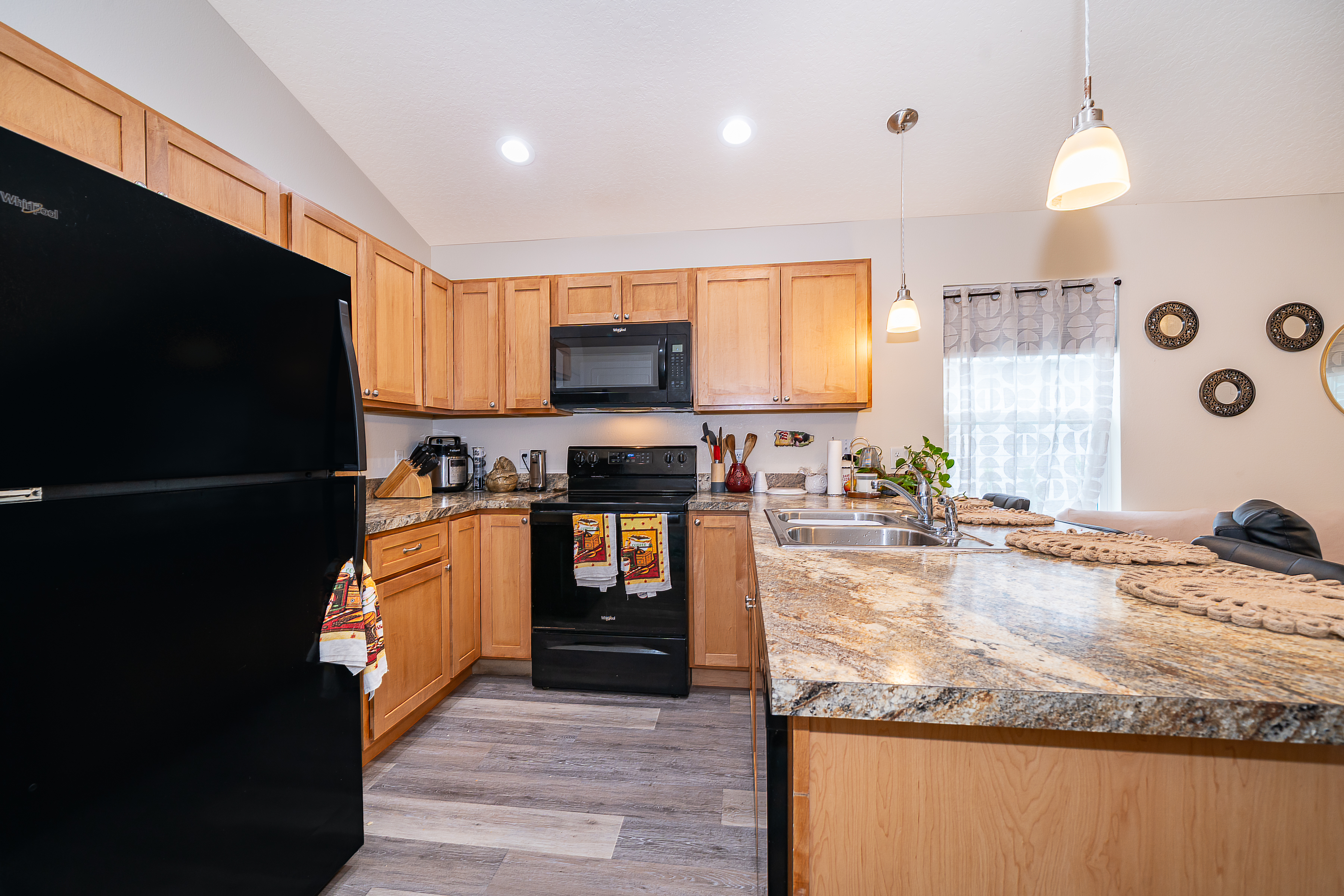 1360 Cottage Circle Tavares, FL 32778 - Photo 10 of 25 a kitchen with stainless steel appliances granite countertop a stove a sink and a refrigerator