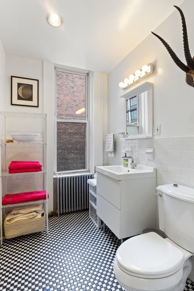 65 Bond Street, Unit 4 Brooklyn, NY 11217 - Photo 6 of 7 a bathroom with a toilet a sink and a mirror