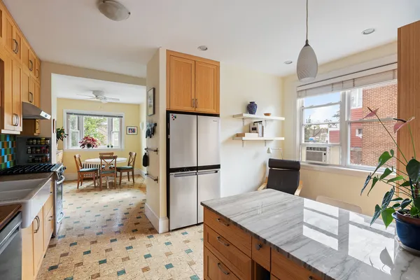 a open kitchen with stainless steel appliances granite countertop a refrigerator and a sink