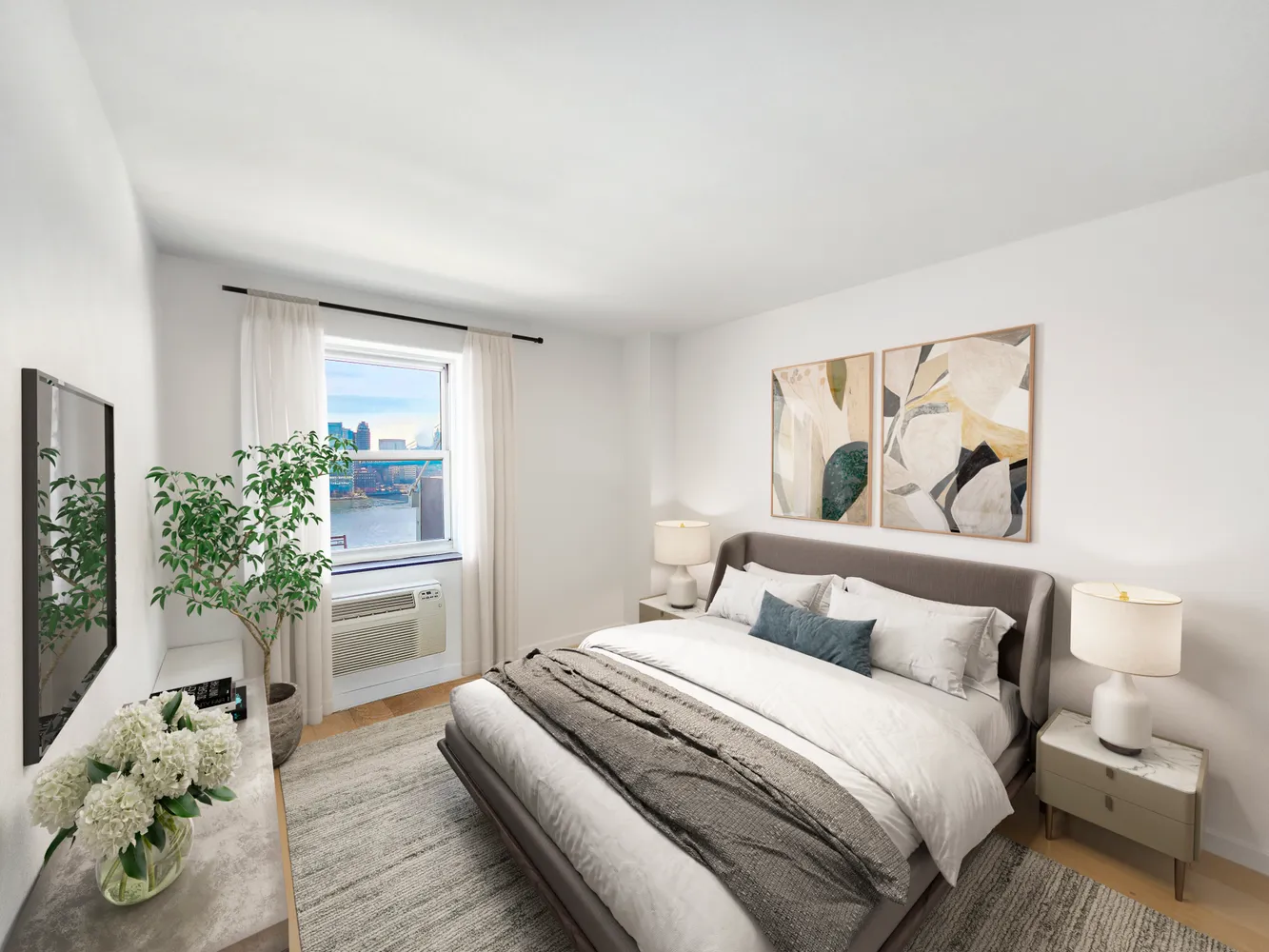 a bedroom with a large bed and a potted plant