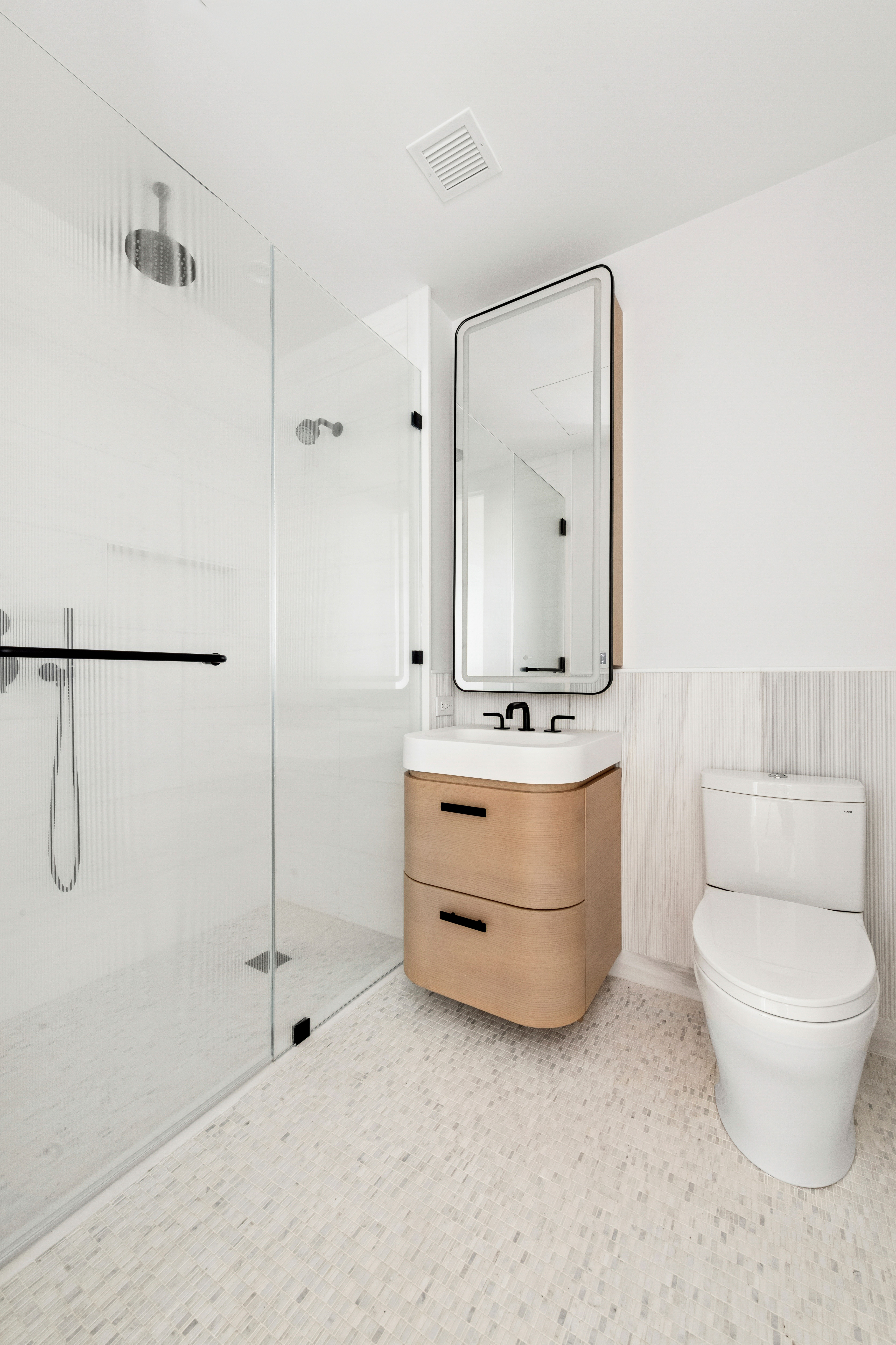 480 Kent Avenue, Unit 21C Brooklyn, NY 11249 - Photo 7 of 23 a bathroom with a double vanity sink mirror and toilet