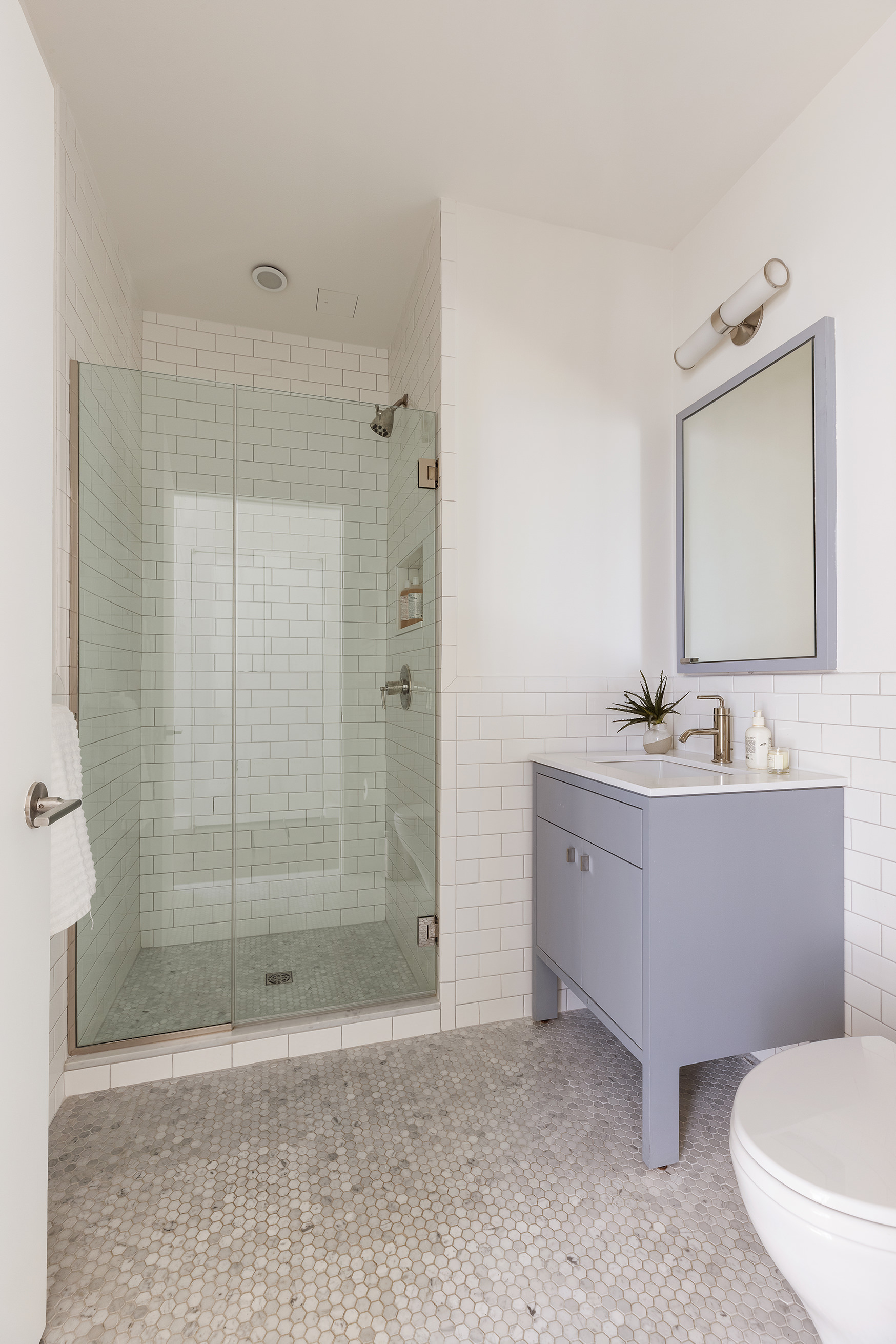 345 Carroll Street, Unit 4B Brooklyn, NY 11231 - Photo 11 of 16 a bathroom with a bathtub shower sink mirror and toilet