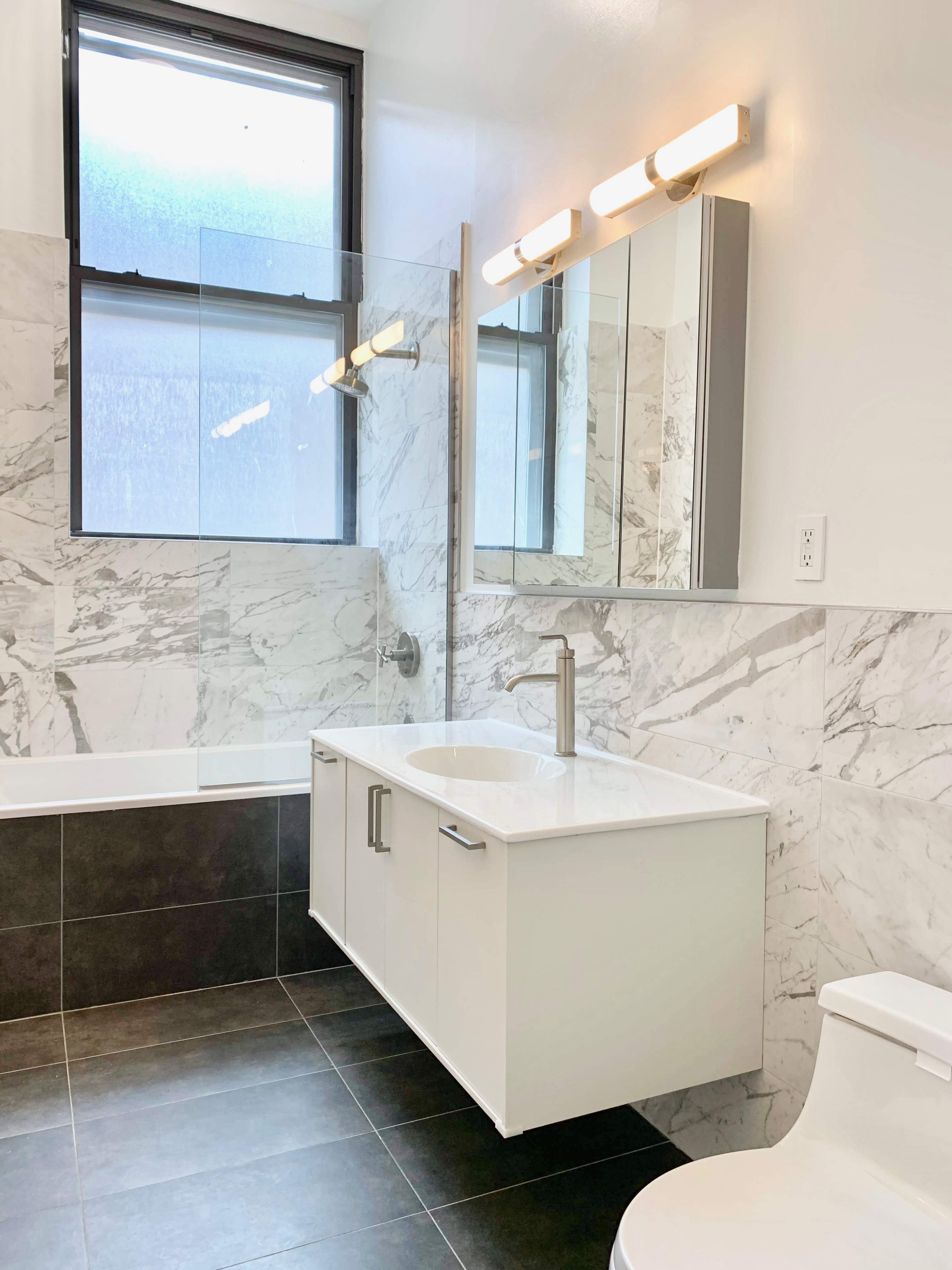 44 Berry Street, Unit 2C Brooklyn, NY 11249 - Photo 6 of 8 a bathroom with a sink and a mirror