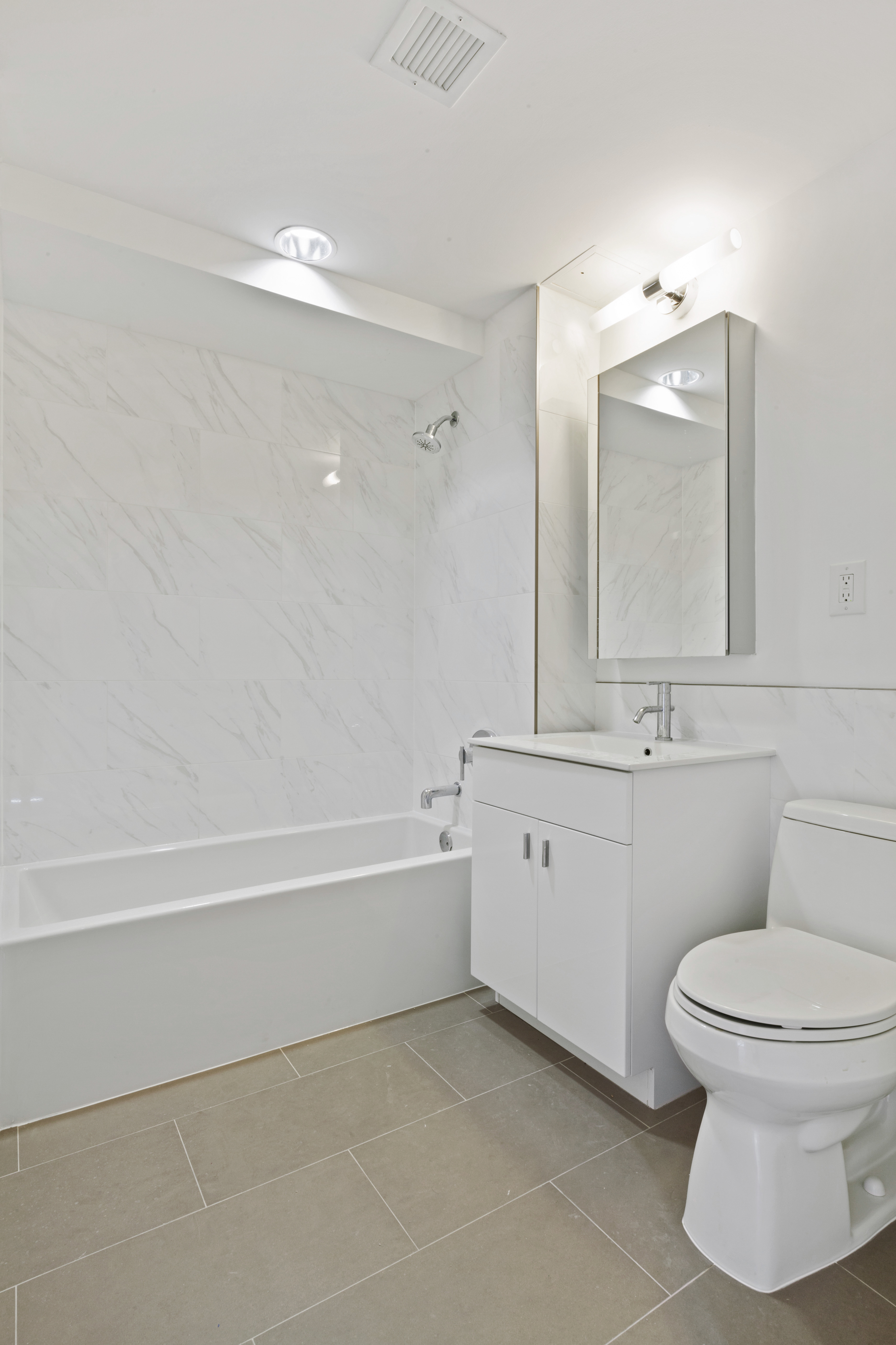 171 West 131st Street, Unit 517 Manhattan, NY 10027 - Photo 4 of 10 a bathroom with a toilet sink and mirror