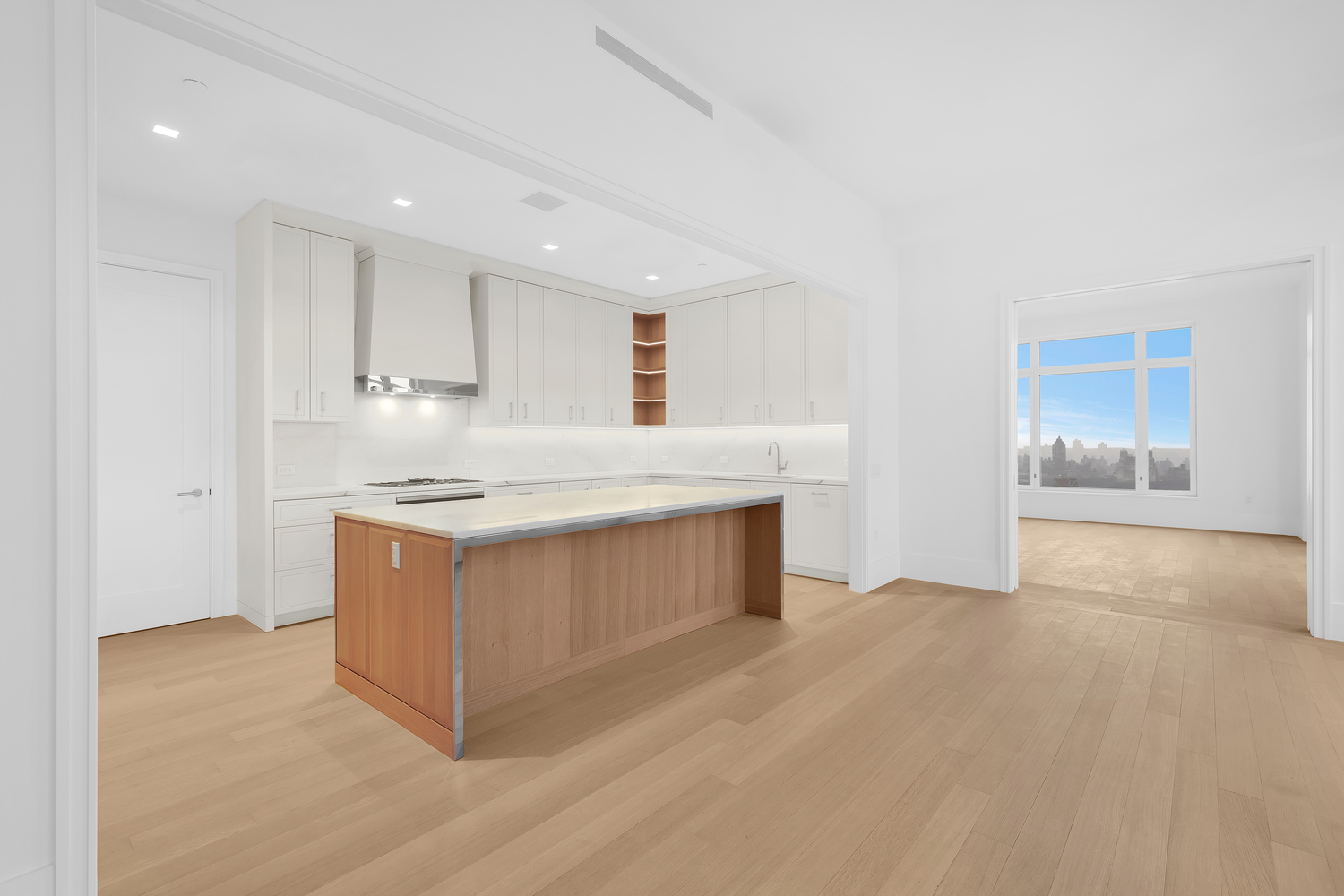 200 East 83rd Street, Unit 34A Manhattan, NY 10028 - Photo 9 of 34 a kitchen with stainless steel appliances granite countertop a stove a sink and a refrigerator with white cabinets