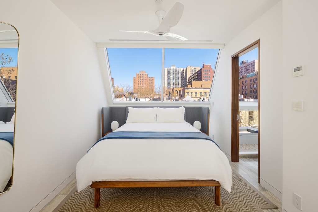 125 West 87th Street Manhattan, NY 10024 - Photo 21 of 27 a bedroom with a bed and lamp