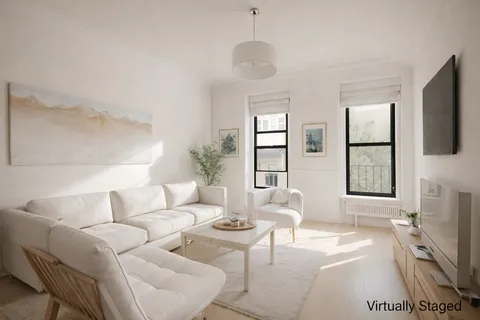 a living room with furniture a flat screen tv and a large window