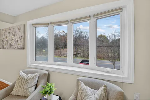 a living room filled with furniture and a window