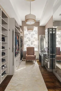 a living room with stainless steel appliances furniture a rug and a view of kitchen