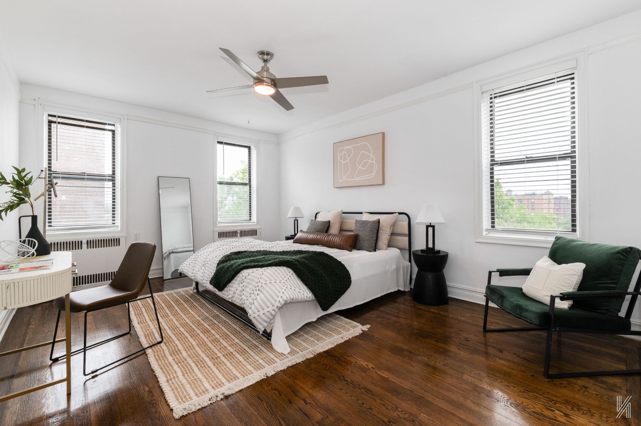 35-06 88th Street, Unit 5E Queens, NY 11372 - Photo 14 of 21 a spacious bedroom with a bed a couch and windows