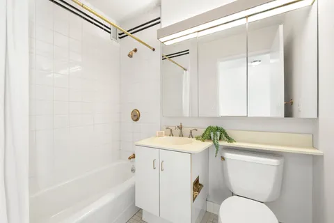 a roof deck with a table and chairs and potted plants