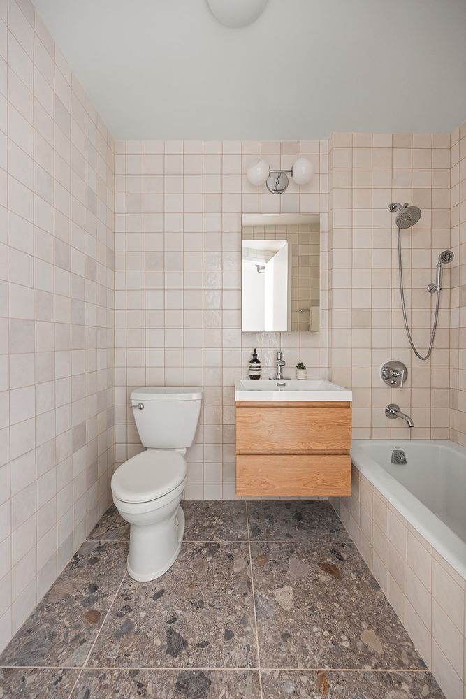 a bathroom with a granite countertop toilet a sink and bathtub