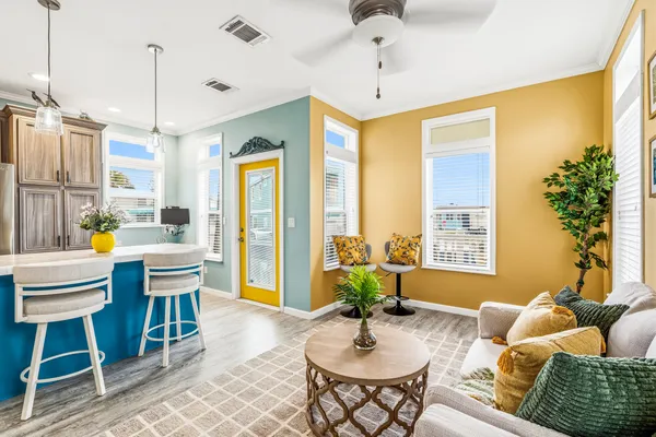 a living room with furniture a chandelier and a window